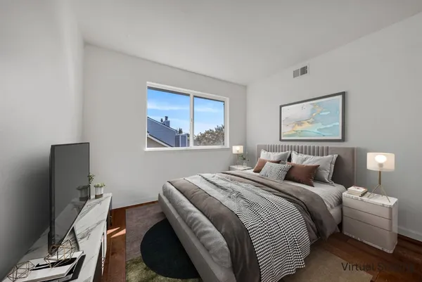 a bedroom with a bed and a flat screen tv