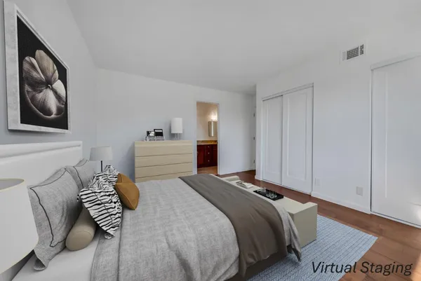 a bedroom with a bed and cabinets