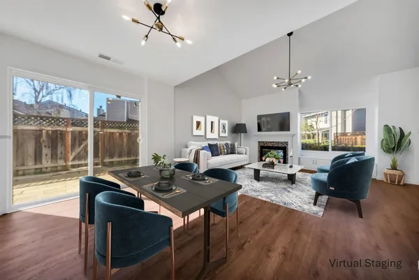 a living room with fireplace furniture and a wooden floor