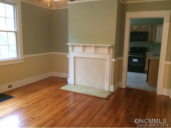 34 Sayles Road Asheville, NC 28803 - Photo 4 of 6 an empty room with wooden floor cabinet and windows