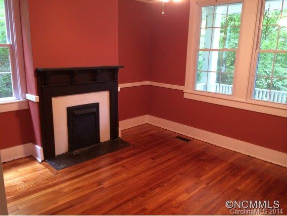 34 Sayles Road Asheville, NC 28803 - Photo 5 of 6 a view of empty room with wooden floor and fireplace
