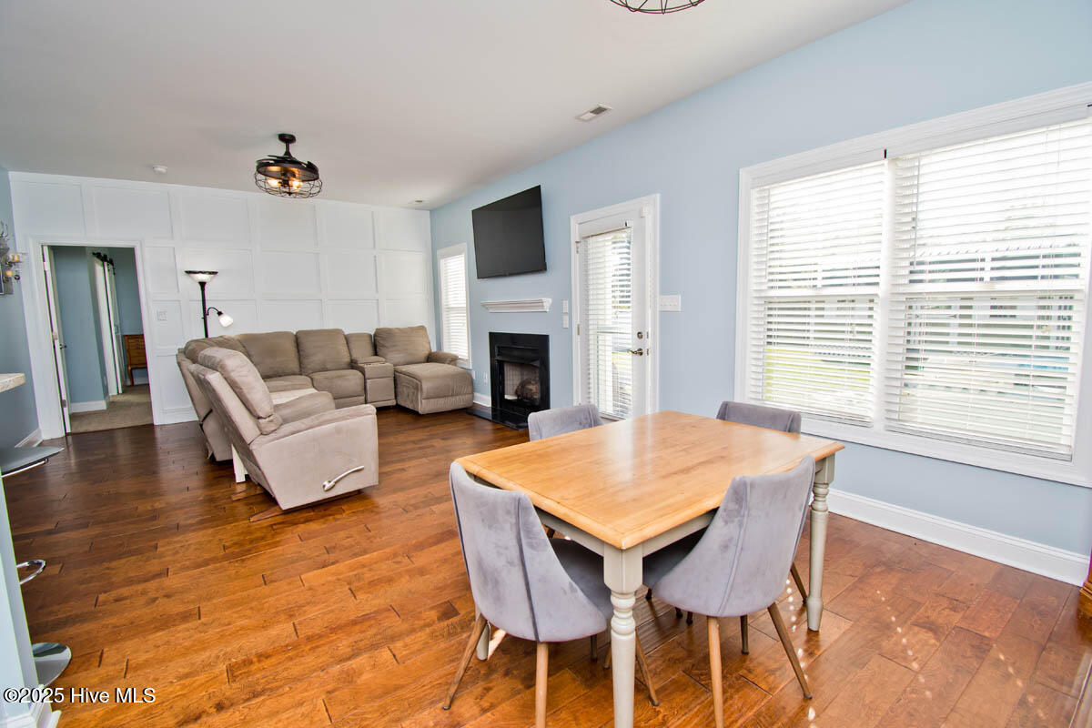 213 Echo Ridge Road Swansboro, NC 28584 - Photo 5 of 35 Great Room with Fireplace, Paneled Wall and Hardwood Floors