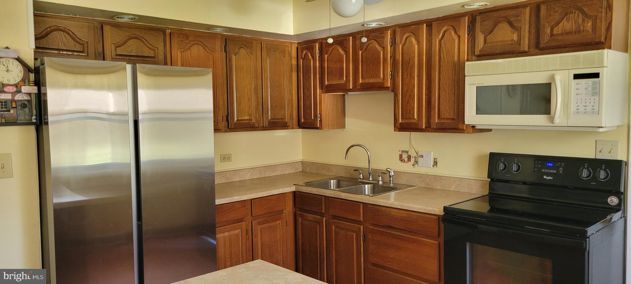 3007 Ogletown Road Newark, DE 19713 - Photo 12 of 25 a kitchen with stainless steel appliances granite countertop a refrigerator and a sink
