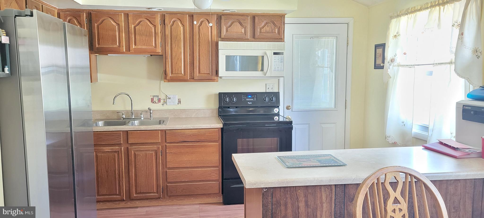 3007 Ogletown Road Newark, DE 19713 - Photo 13 of 25 a kitchen with stainless steel appliances granite countertop a sink stove and refrigerator