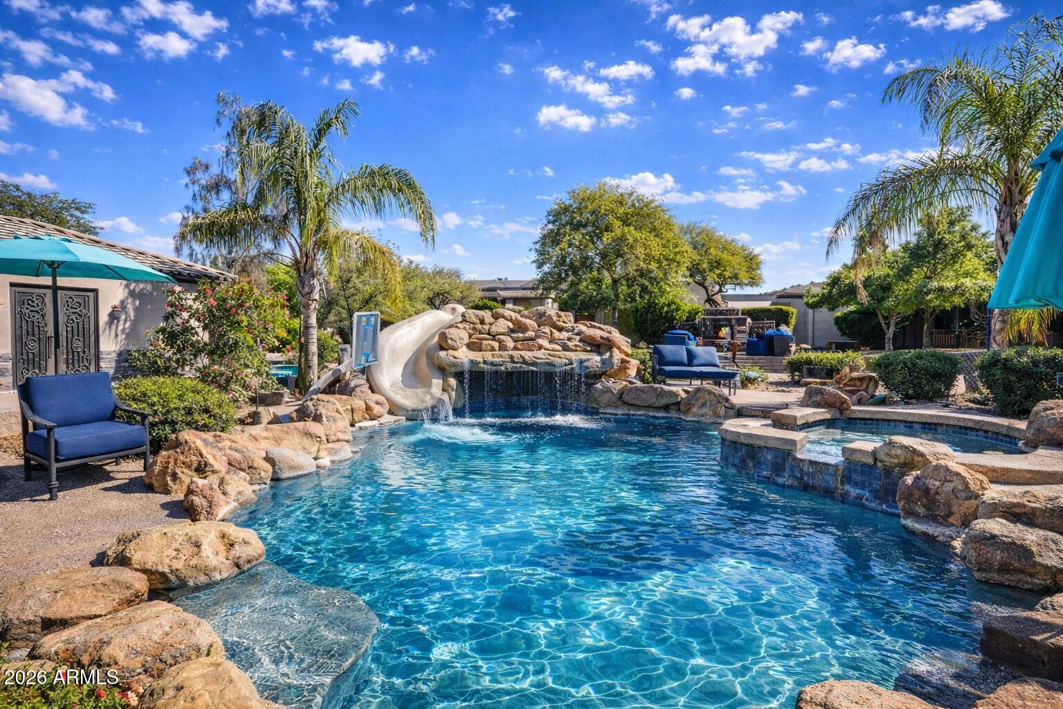 1406 West Joy Ranch Road Phoenix, AZ 85086 - Photo 1 of 58 a view of a backyard with couches table and chairs and potted plants