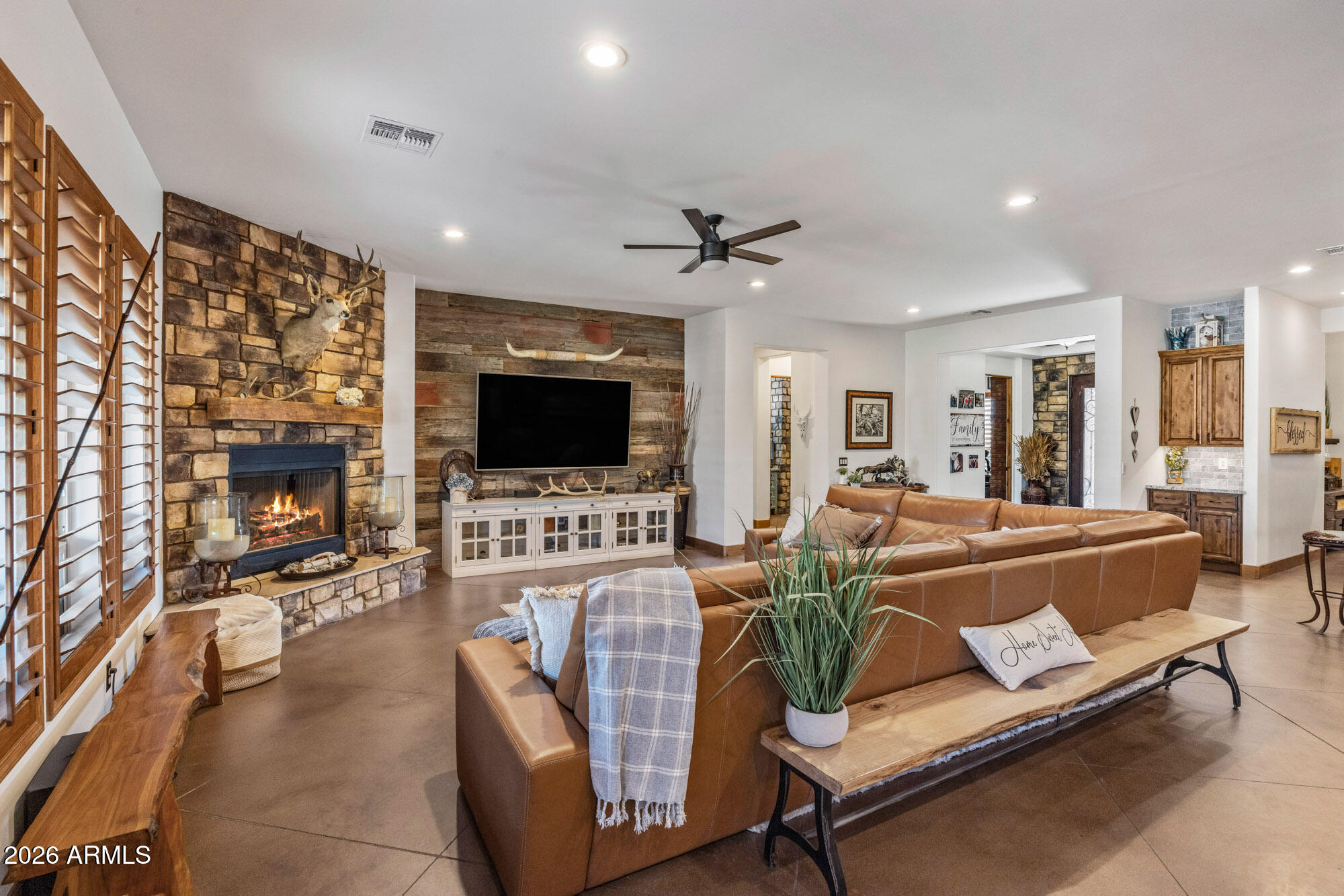 1406 West Joy Ranch Road Phoenix, AZ 85086 - Photo 14 of 58 a living room with furniture fireplace and a flat screen tv