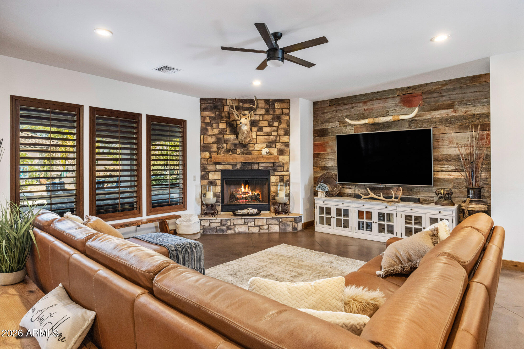 1406 West Joy Ranch Road Phoenix, AZ 85086 - Photo 15 of 58 a living room with furniture and a flat screen tv