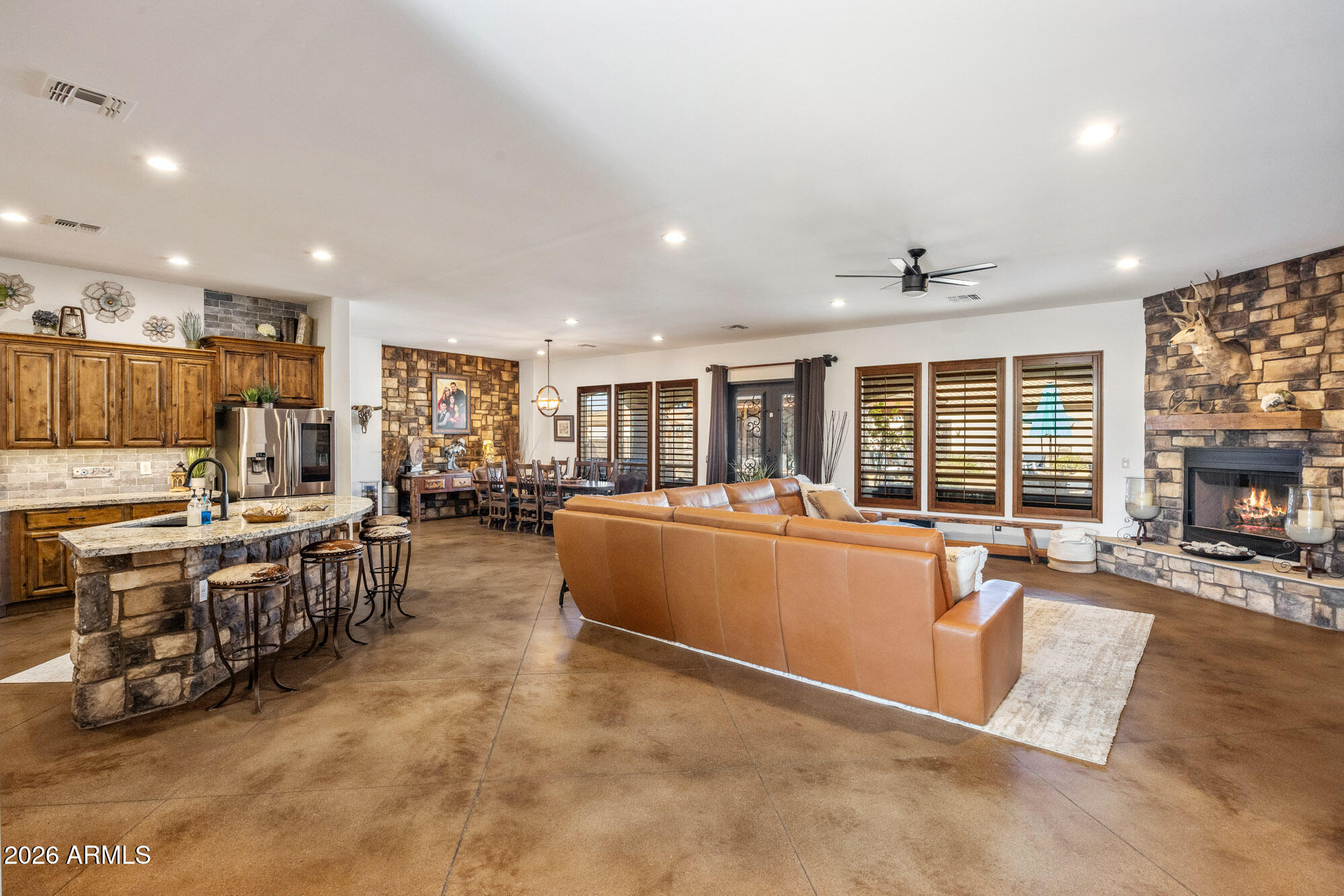 1406 West Joy Ranch Road Phoenix, AZ 85086 - Photo 17 of 58 a large living room with stainless steel appliances granite countertop a couch and a large window