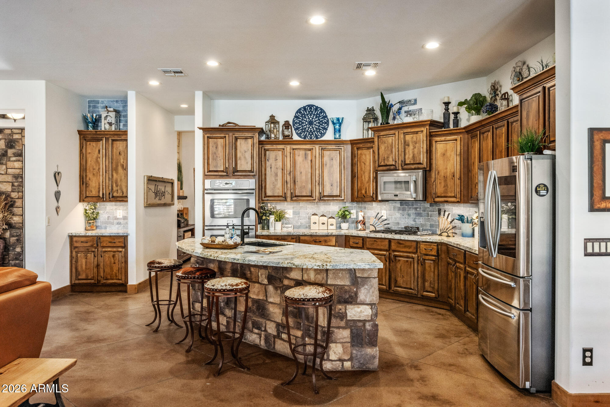 1406 West Joy Ranch Road Phoenix, AZ 85086 - Photo 18 of 58 a kitchen with stainless steel appliances granite countertop a refrigerator a stove a sink and a dining table with wooden floor