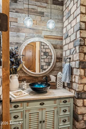a bathroom with a tub sink and mirror