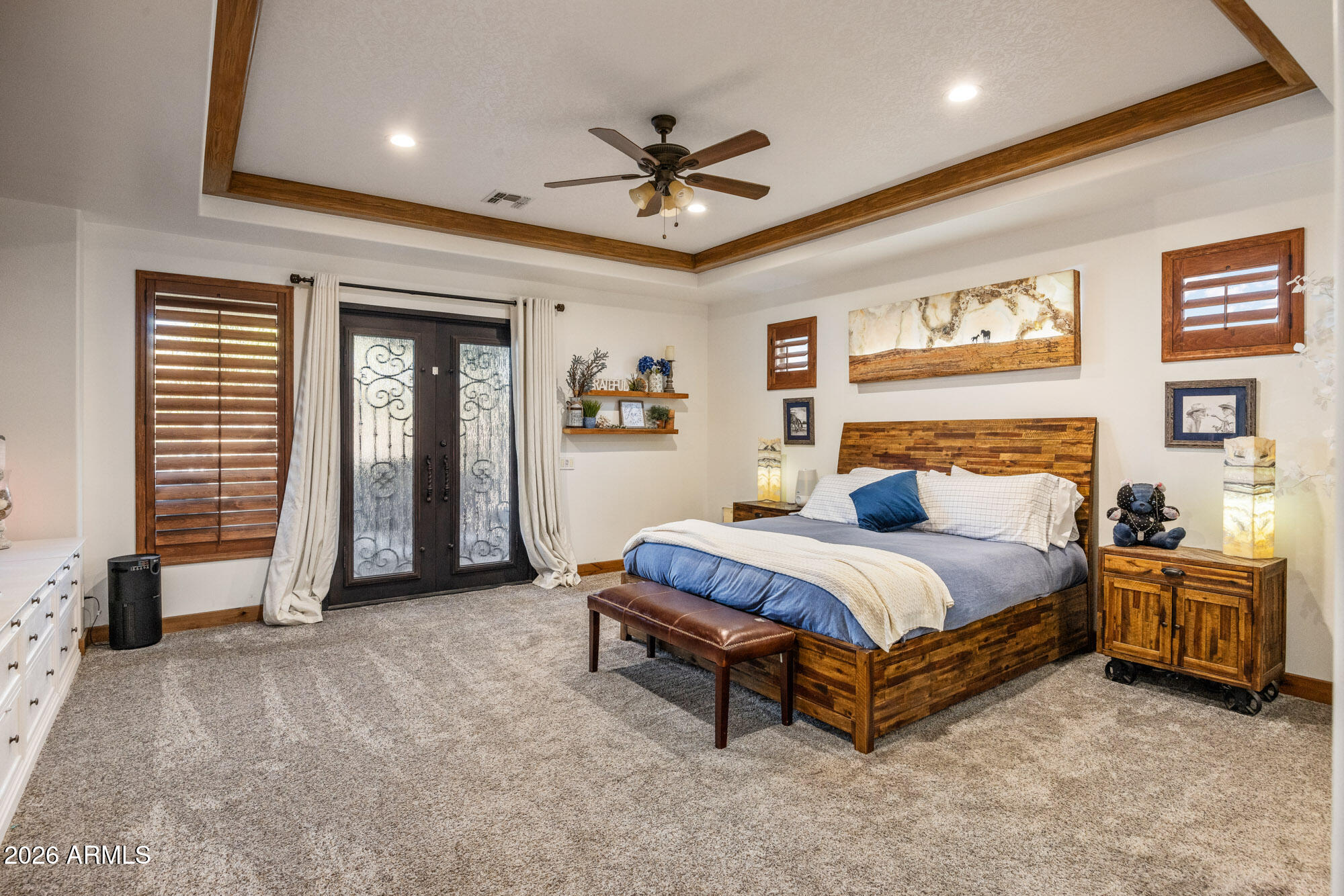 1406 West Joy Ranch Road Phoenix, AZ 85086 - Photo 27 of 58 a spacious bedroom with a bed and a chandelier