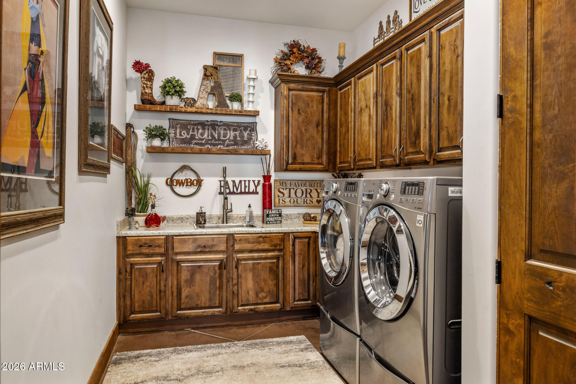 1406 West Joy Ranch Road Phoenix, AZ 85086 - Photo 31 of 58 a utility room with a stove a washer and dryer