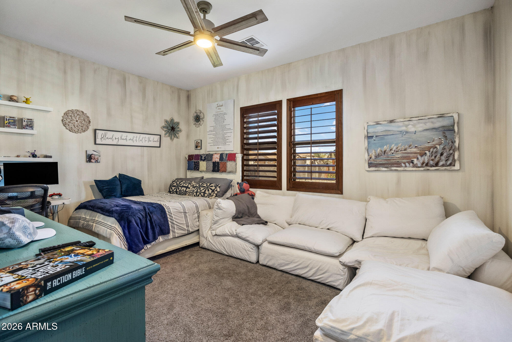 1406 West Joy Ranch Road Phoenix, AZ 85086 - Photo 32 of 58 a living room with furniture ceiling fan and a window