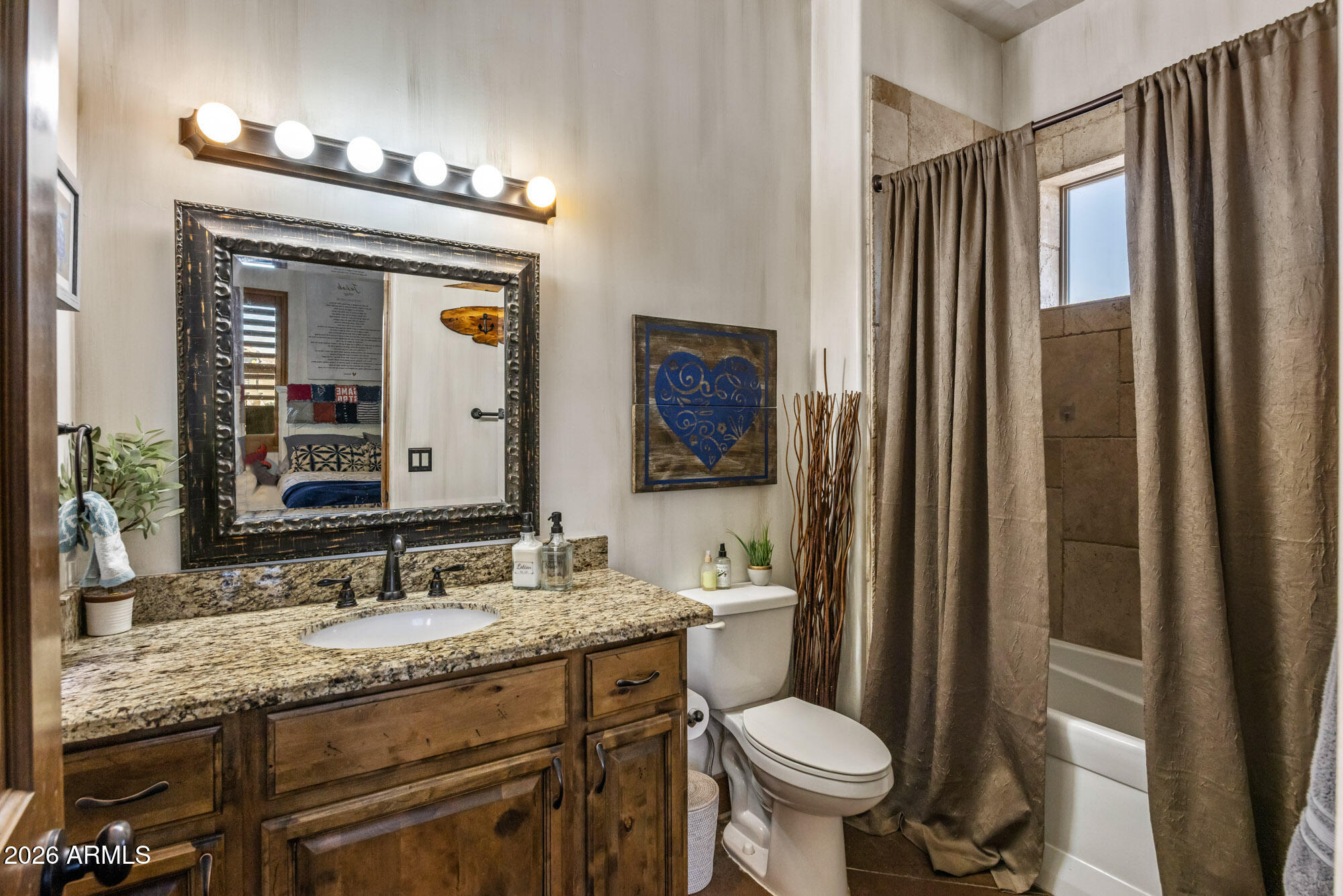 1406 West Joy Ranch Road Phoenix, AZ 85086 - Photo 33 of 58 a bathroom with a granite countertop toilet a sink and a mirror