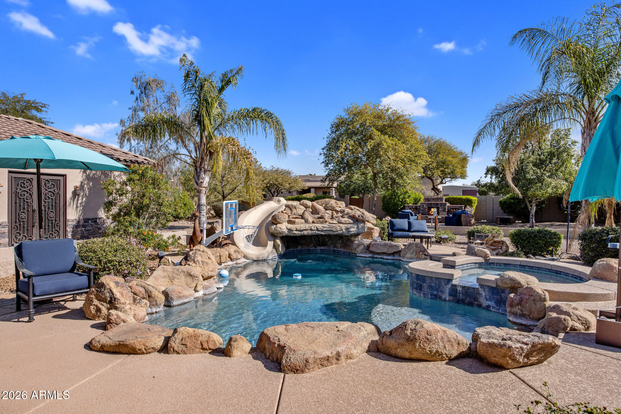 1406 West Joy Ranch Road Phoenix, AZ 85086 - Photo 36 of 58 a swimming pool with outdoor seating and yard