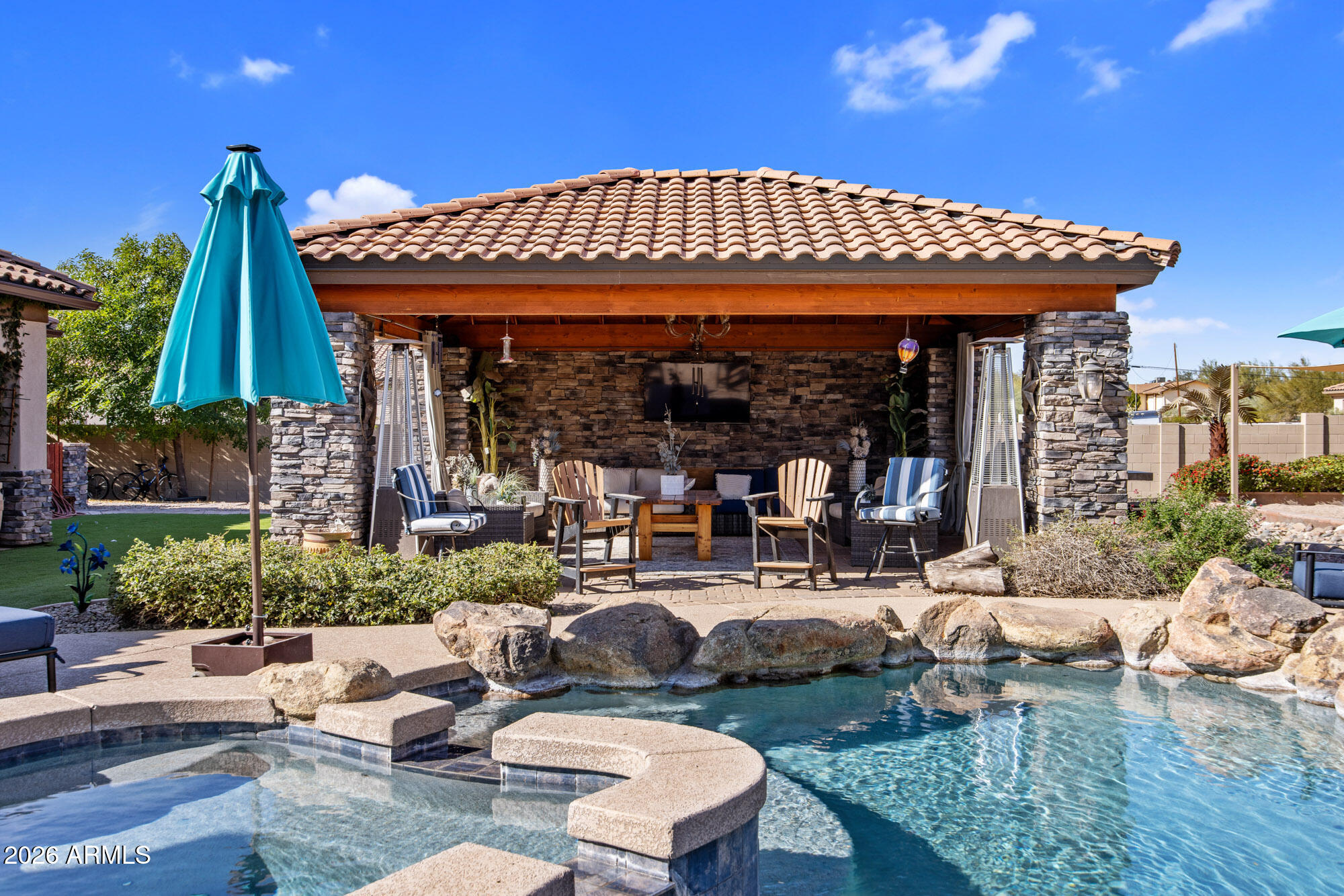 1406 West Joy Ranch Road Phoenix, AZ 85086 - Photo 38 of 58 a view of a patio with table and chairs potted plants and palm tree