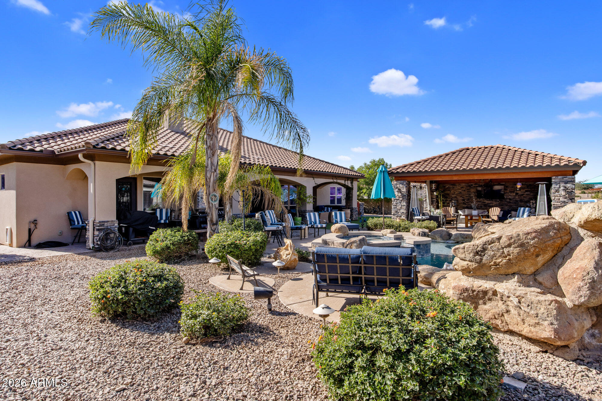 1406 West Joy Ranch Road Phoenix, AZ 85086 - Photo 45 of 58 a view of a cafe with a table and chairs under an umbrella