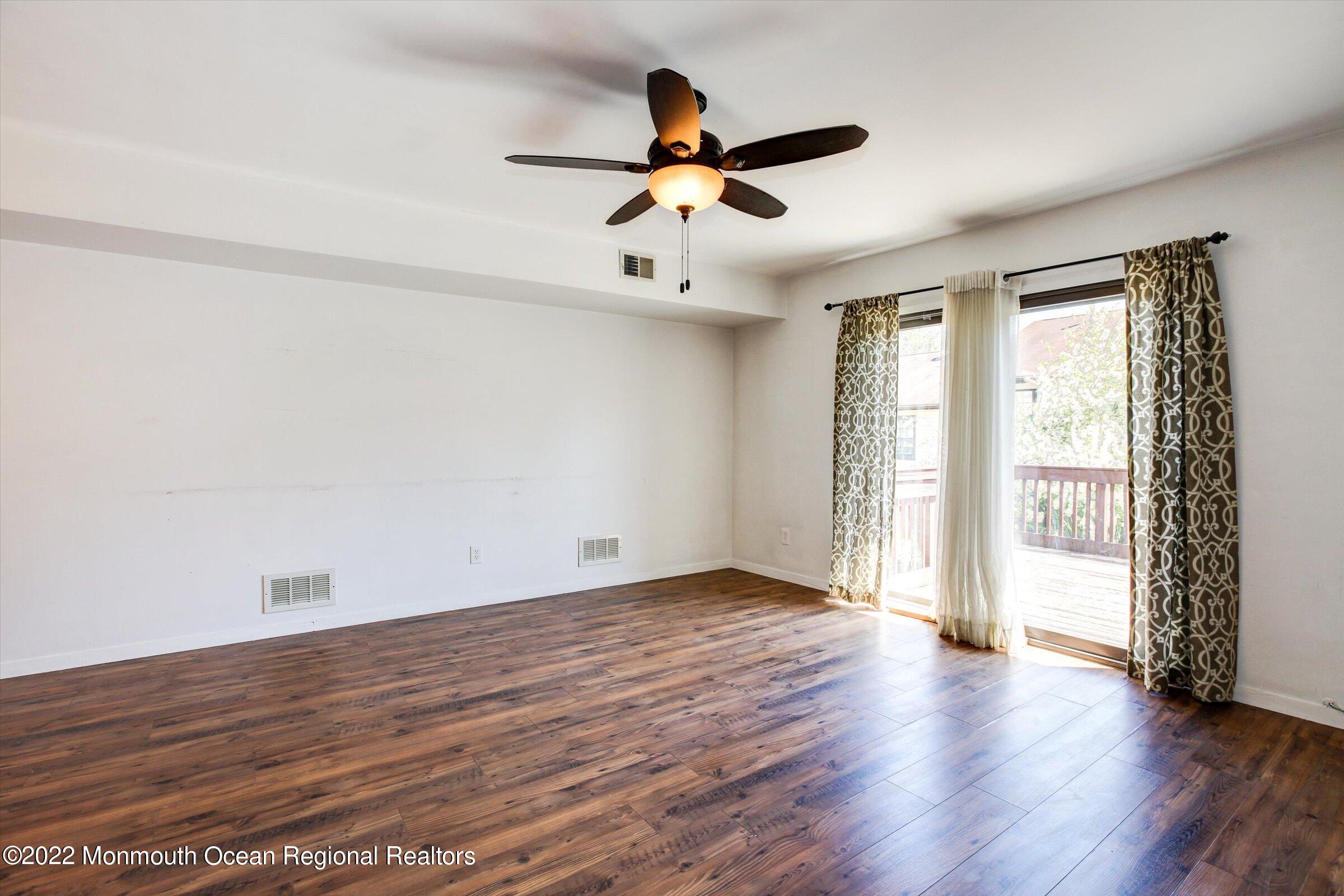 51 Queens Way Englishtown, NJ 07726 - Photo 12 of 25 an empty room with wooden floor and windows