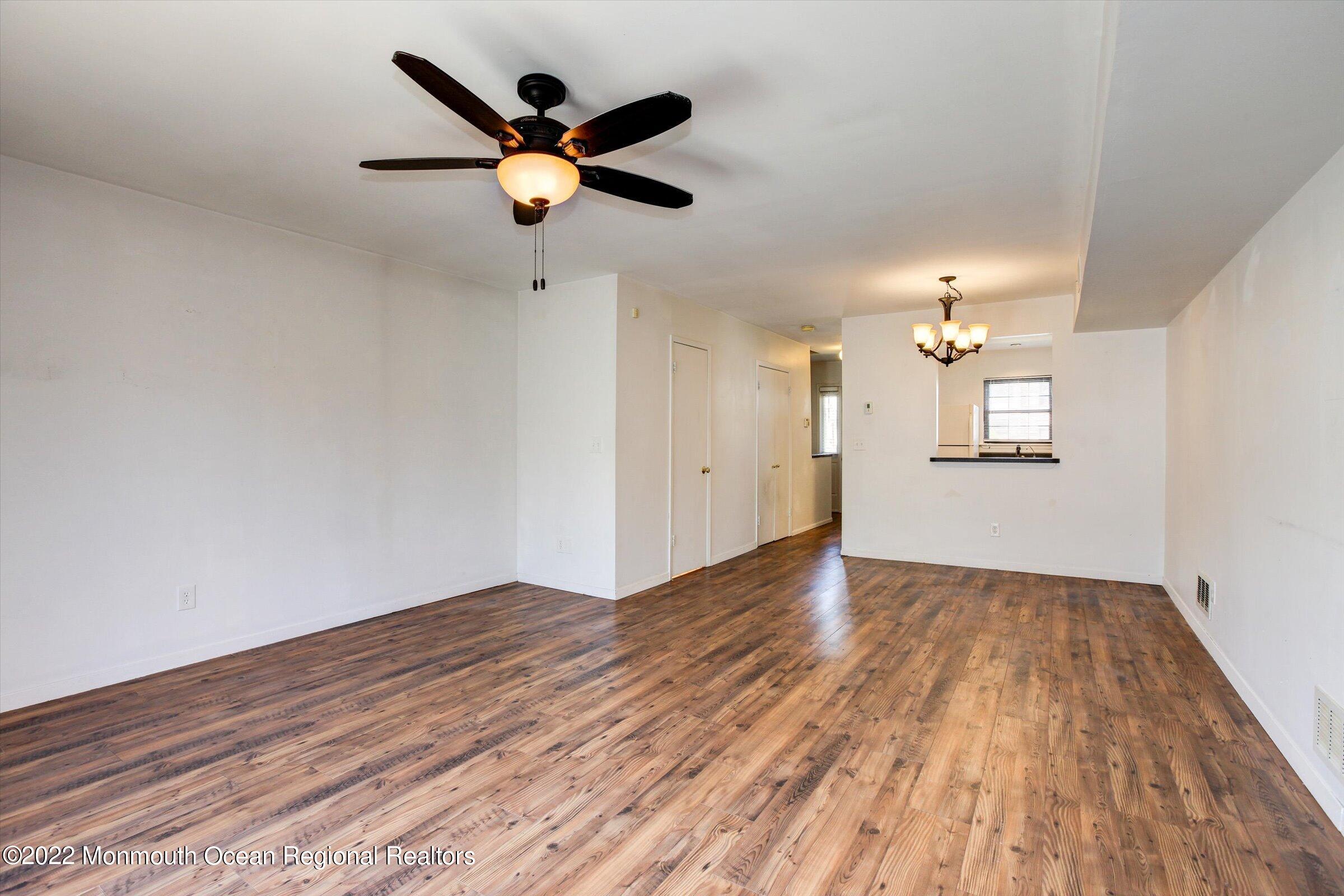 51 Queens Way Englishtown, NJ 07726 - Photo 14 of 25 wooden floor in an empty room with a window