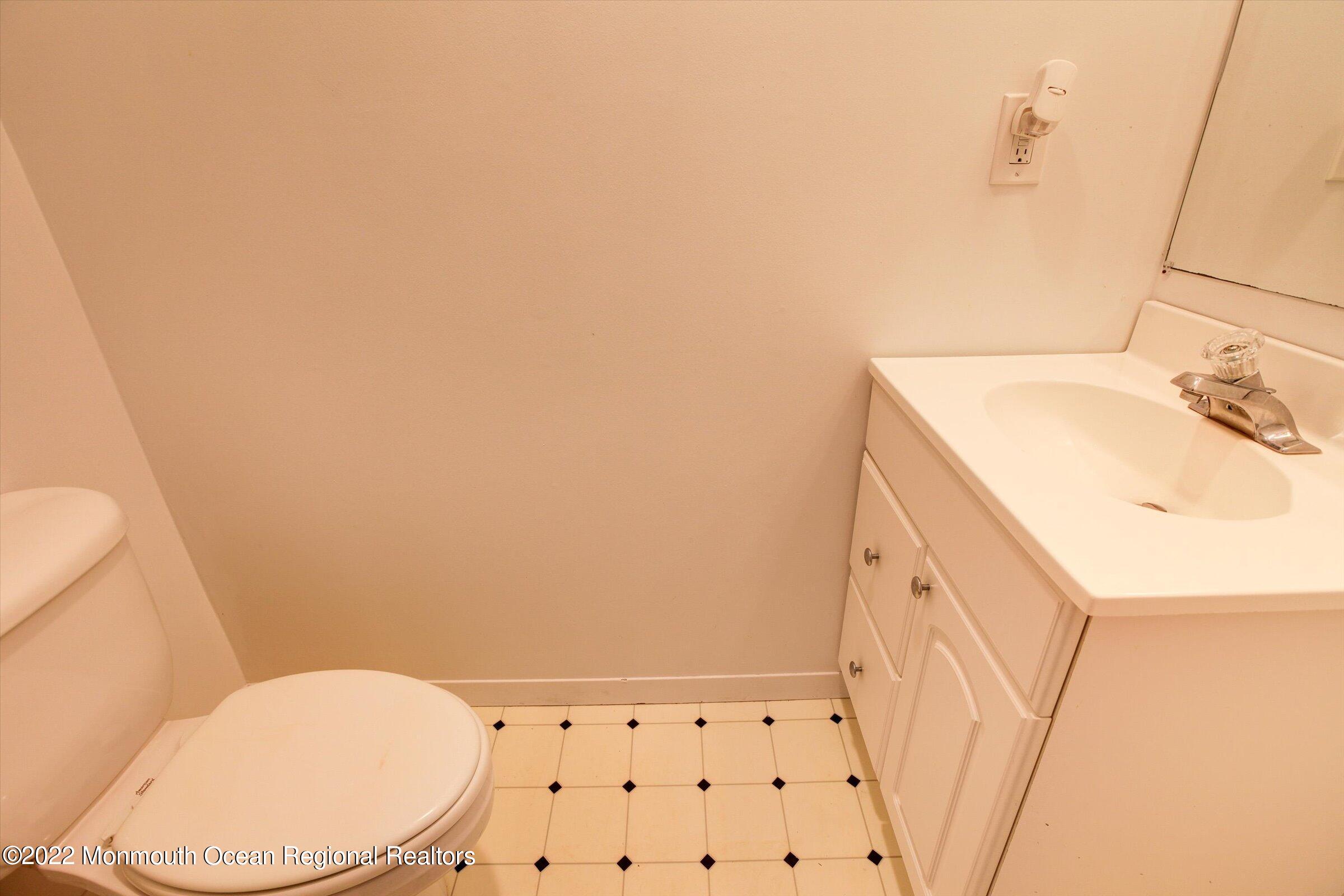 51 Queens Way Englishtown, NJ 07726 - Photo 15 of 25 a bathroom with a sink a toilet and a mirror