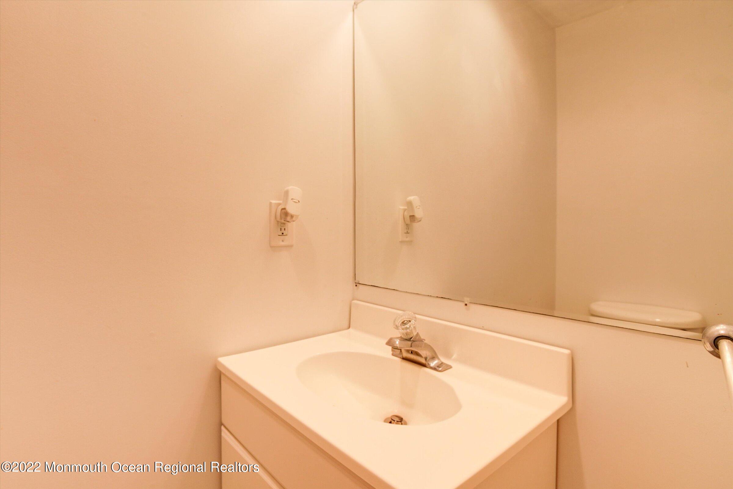 51 Queens Way Englishtown, NJ 07726 - Photo 16 of 25 a bathroom with a sink and a mirror