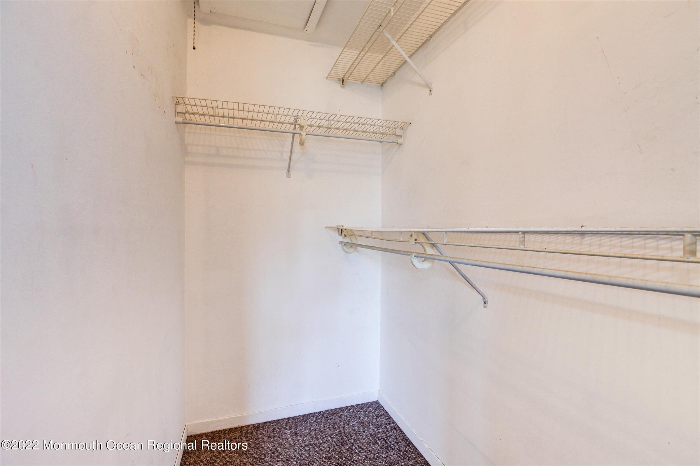 51 Queens Way Englishtown, NJ 07726 - Photo 19 of 25 a view of a room with racks on the wall