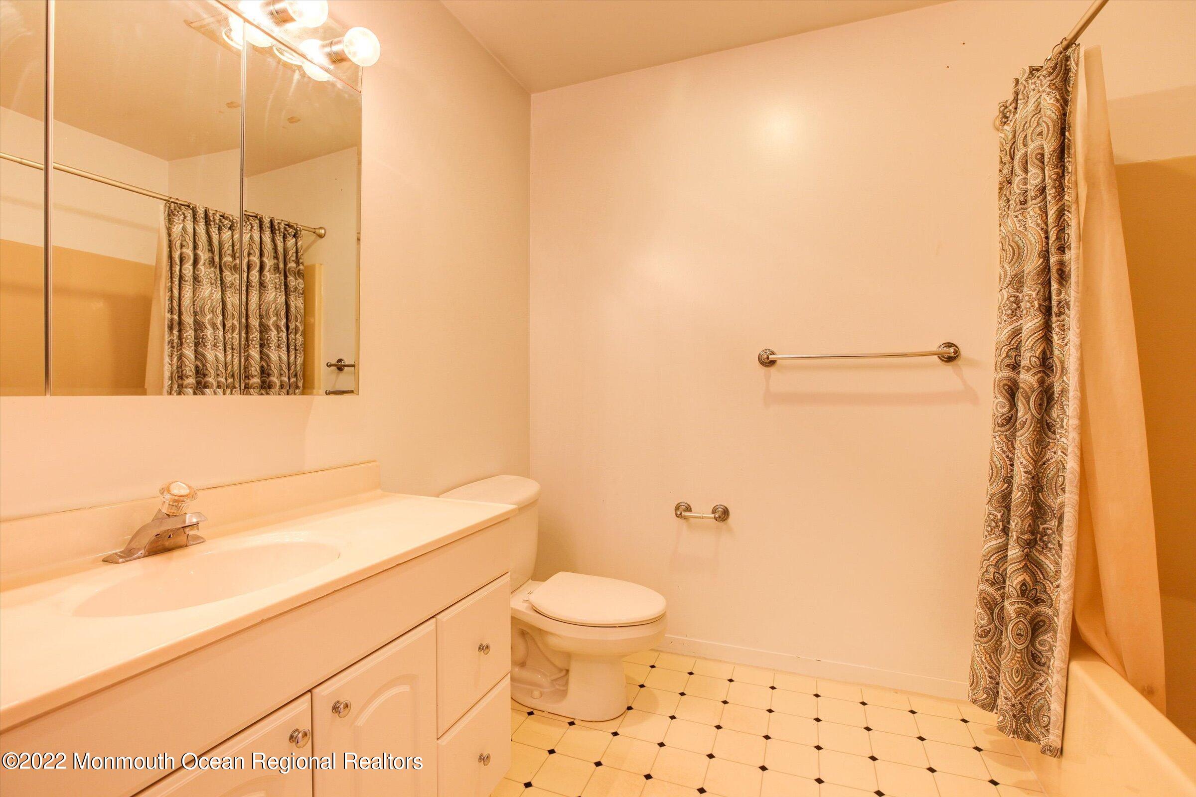 51 Queens Way Englishtown, NJ 07726 - Photo 22 of 25 a bathroom with a sink a toilet and shower