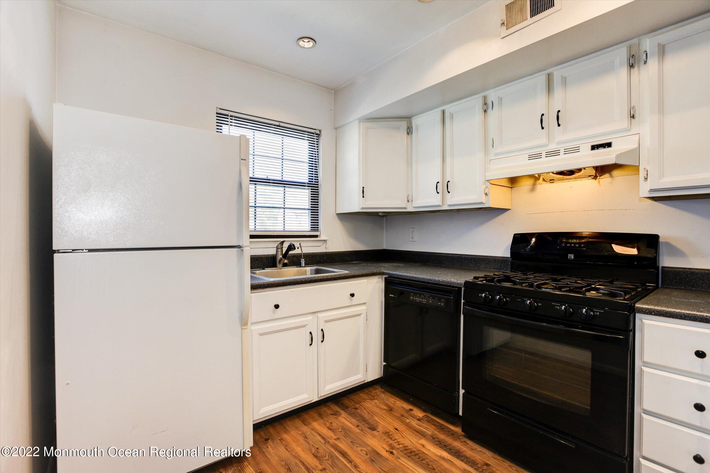 51 Queens Way Englishtown, NJ 07726 - Photo 4 of 25 a kitchen with stainless steel appliances granite countertop a stove a refrigerator and a cabinets