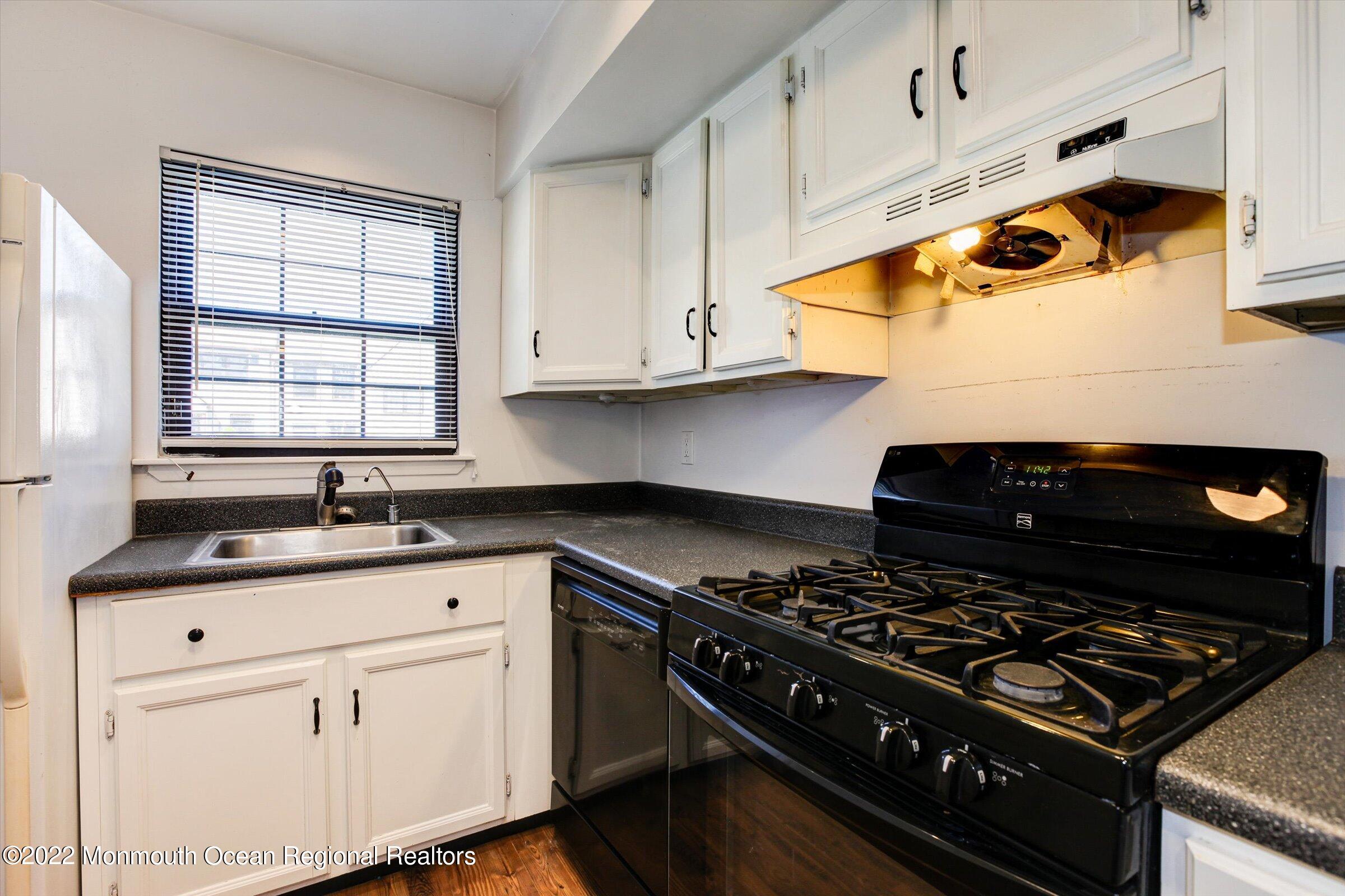 51 Queens Way Englishtown, NJ 07726 - Photo 5 of 25 a kitchen with white cabinets and appliances