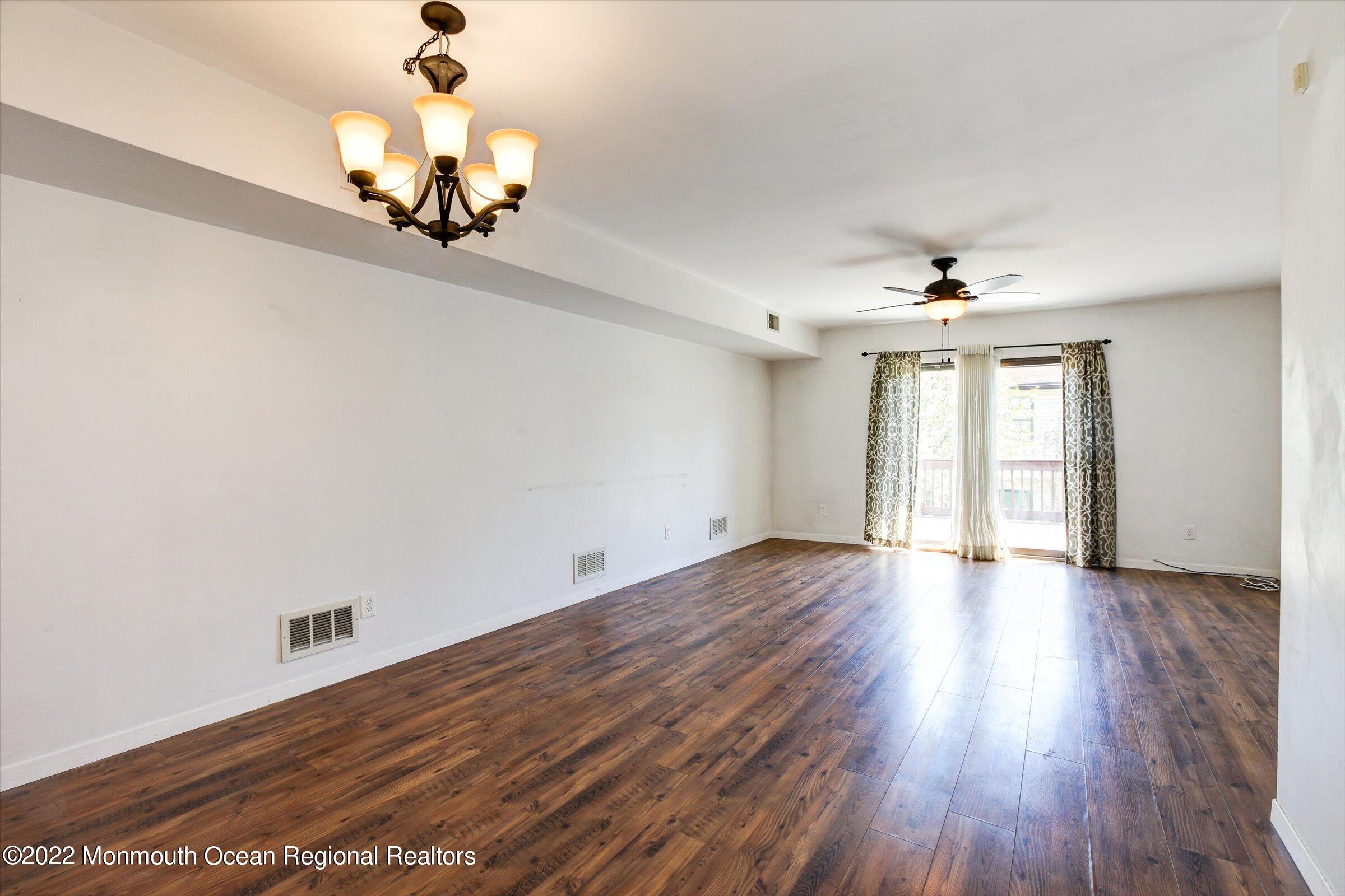 51 Queens Way Englishtown, NJ 07726 - Photo 8 of 25 wooden floor in an empty room with a window