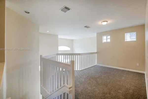 a view of a hallway with windows
