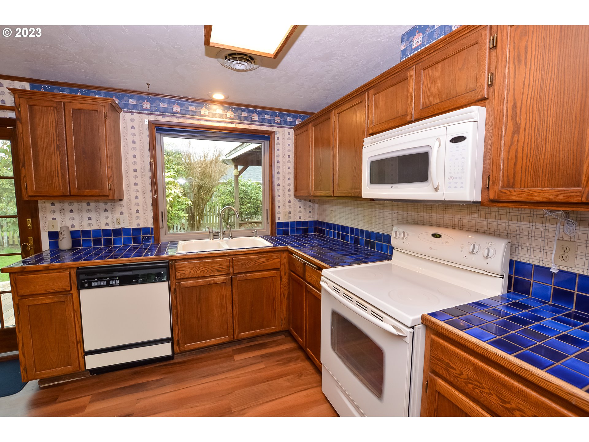 2470 16th Street Springfield, OR 97477 - Photo 13 of 32 a kitchen with stainless steel appliances granite countertop a stove a sink and a microwave
