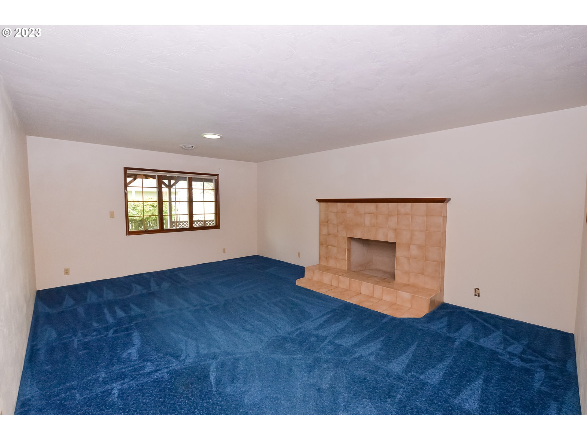 2470 16th Street Springfield, OR 97477 - Photo 5 of 32 a view of an empty room with a window and a kitchen