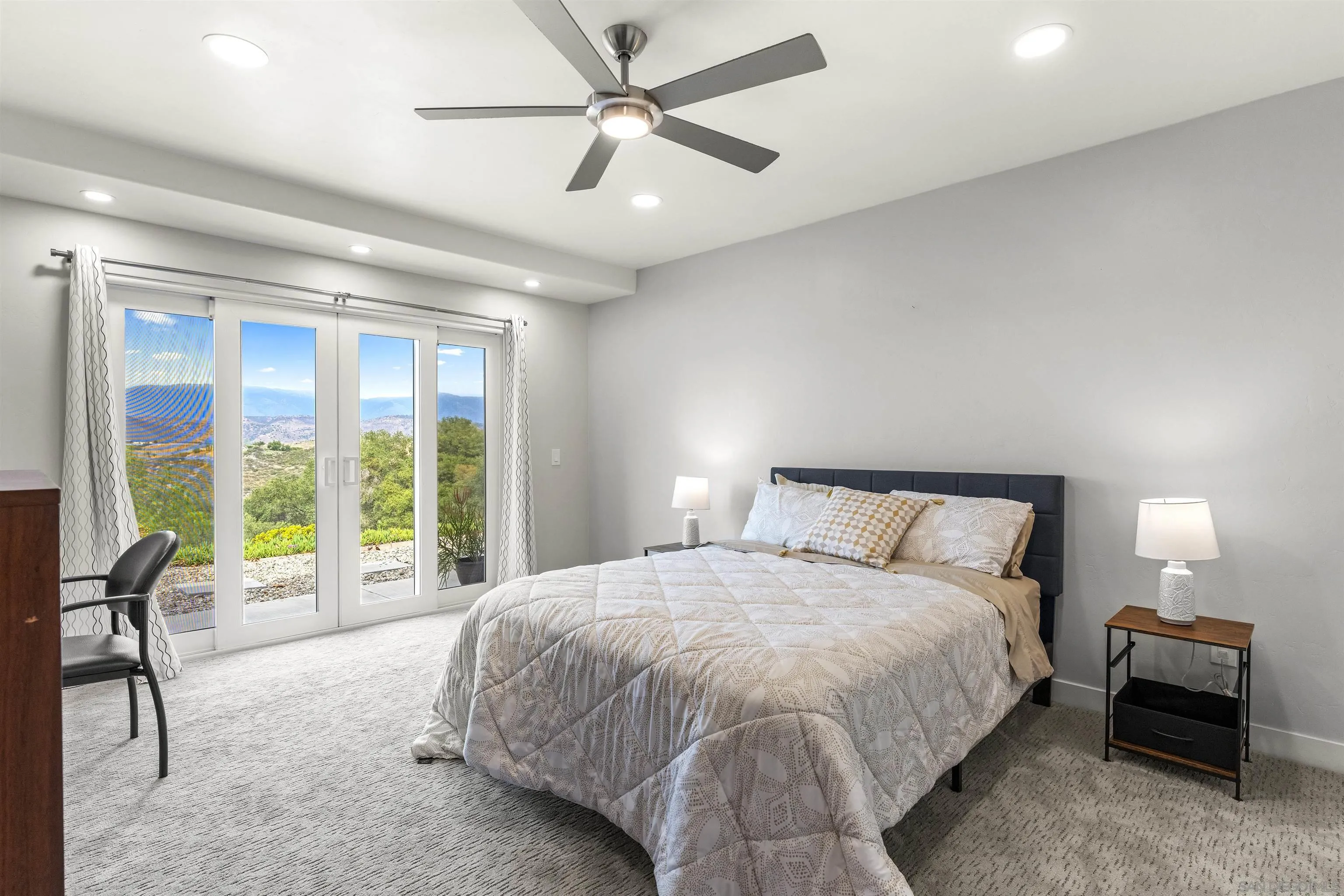 30659 Diaz Road Valley Center, CA 92082 - Photo 29 of 44 a spacious bedroom with a bed and a large window