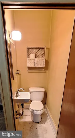 a white toilet sitting next to a sink