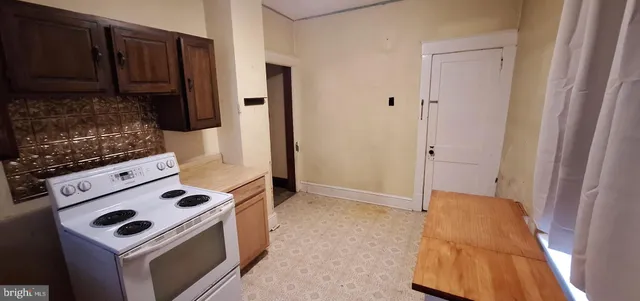 a kitchen with a stove and a refrigerator