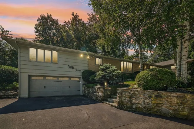 a front view of a house with plants
