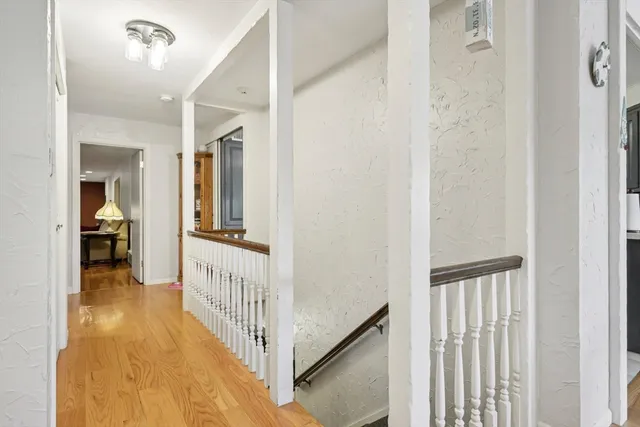 a view of a hallway with a livingroom and a bathroom
