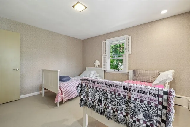 a bedroom with a bed and window