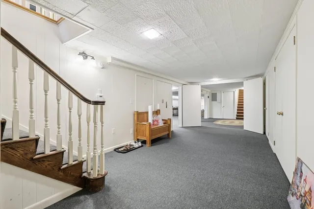 a view of a livingroom with furniture and staircase
