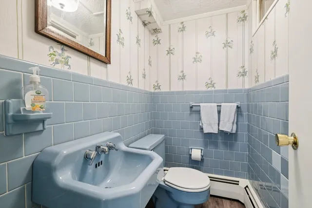 a bathroom with a sink a toilet and a mirror