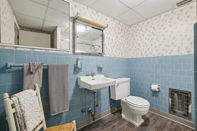 a bathroom with a sink a toilet and a mirror