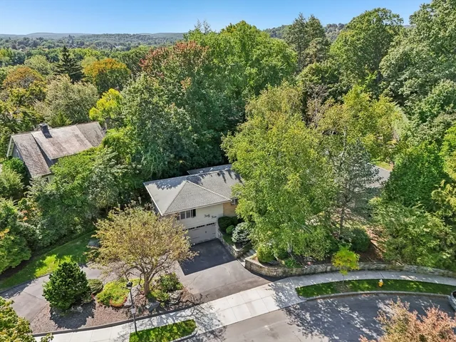 an aerial view of a house with a yard