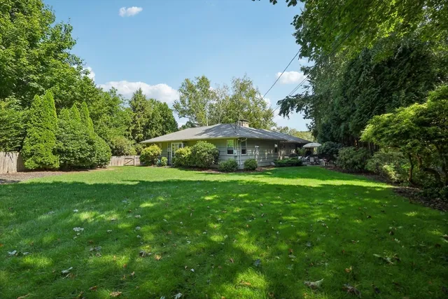 a view of a house with a yard and sitting area