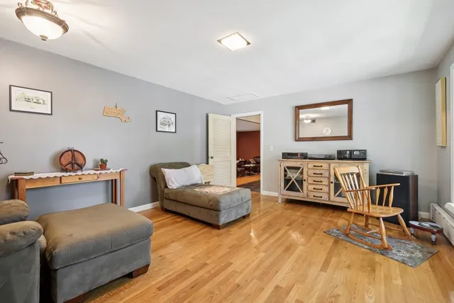 a living room with furniture and a wooden floor