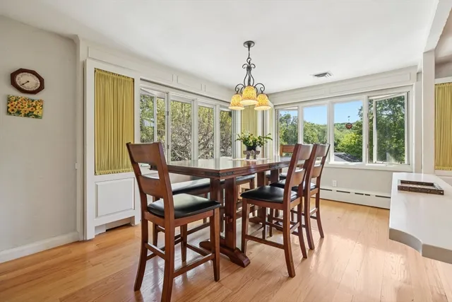 a view of a dining room with furniture window and wooden floor