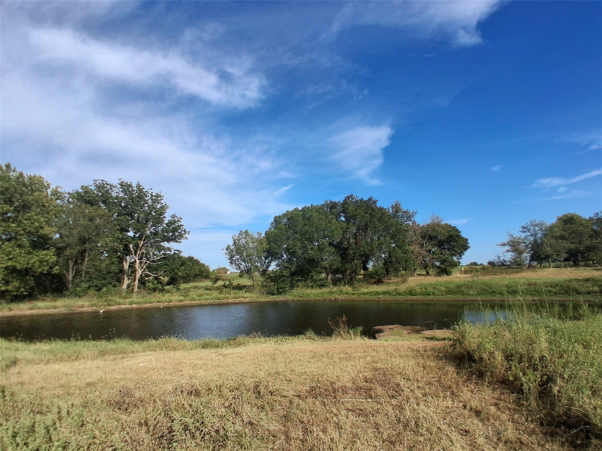 9644 19th Road Nowata, OK 74048 - Photo 34 of 36 Pond feature with surrounding natural vegetation and mature trees
