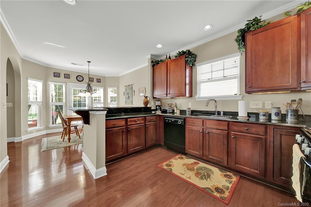 320 Sand Paver Way Fort Mill, SC 29708 - Photo 12 of 42 a kitchen with stainless steel appliances granite countertop a stove a sink dishwasher and a refrigerator with wooden floor