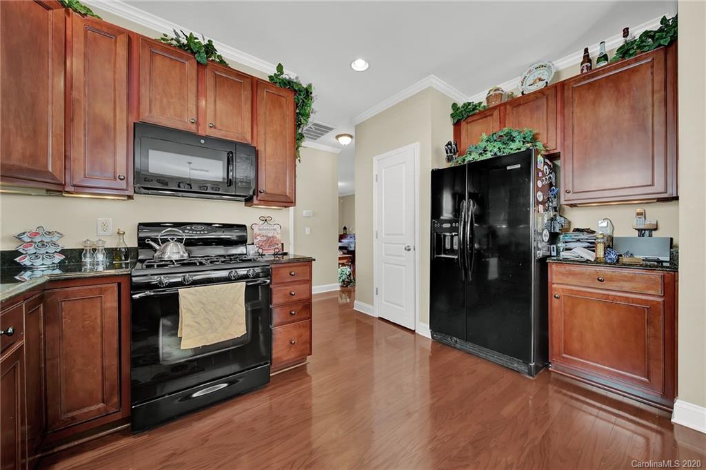 320 Sand Paver Way Fort Mill, SC 29708 - Photo 13 of 42 a kitchen with stainless steel appliances granite countertop a refrigerator stove and sink