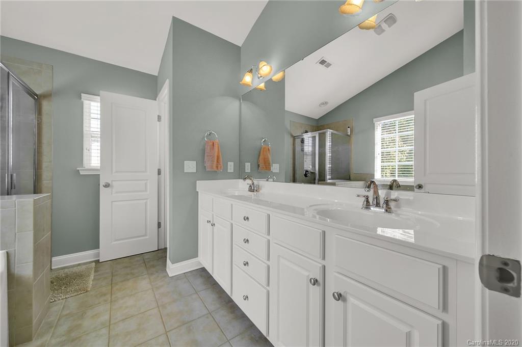 320 Sand Paver Way Fort Mill, SC 29708 - Photo 23 of 42 a spacious bathroom with a double vanity sink a mirror and a shower